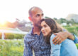 Photo of a man and woman smiling and embracing in a happy relationship.