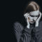 Image of woman in need of PTSD treatment holding her head