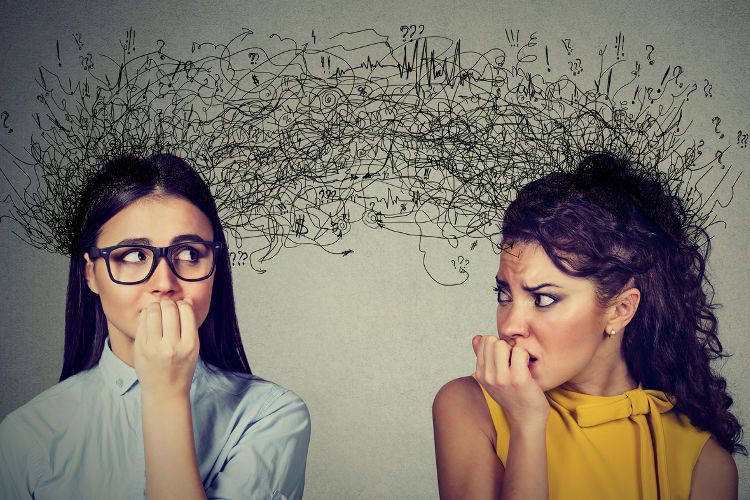 Image of two women who appear stressed out and anxious, who might benefit from cognitive behavioral therapy treatment.